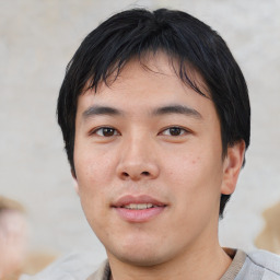 Joyful asian young-adult male with short  black hair and brown eyes