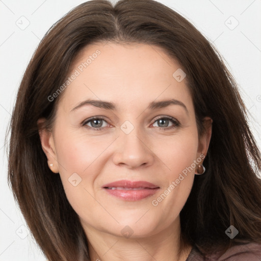 Joyful white adult female with long  brown hair and brown eyes