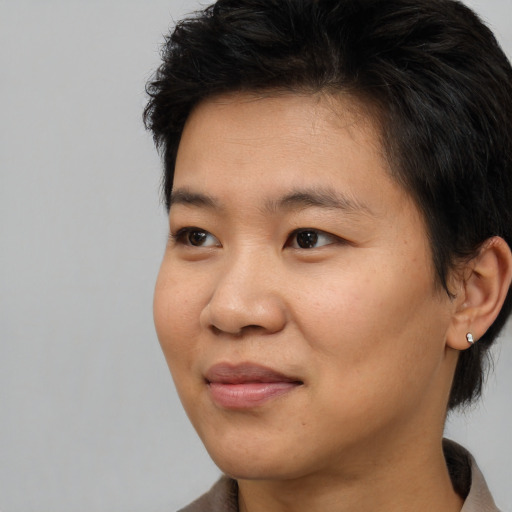 Joyful asian young-adult female with medium  brown hair and brown eyes