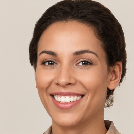 Joyful white young-adult female with medium  brown hair and brown eyes