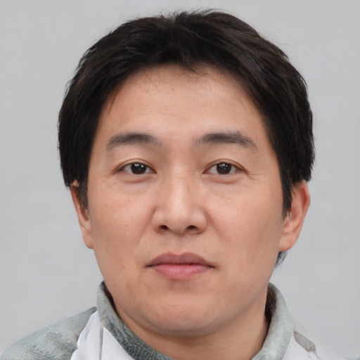 Neutral asian adult male with short  brown hair and brown eyes