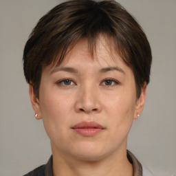 Joyful asian young-adult female with short  brown hair and brown eyes