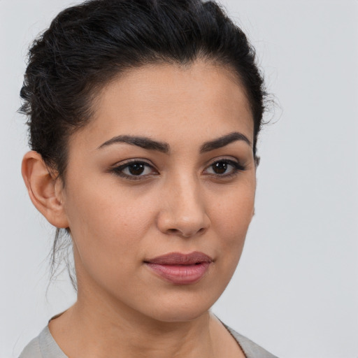 Joyful latino young-adult female with short  brown hair and brown eyes