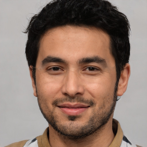 Joyful white young-adult male with short  black hair and brown eyes