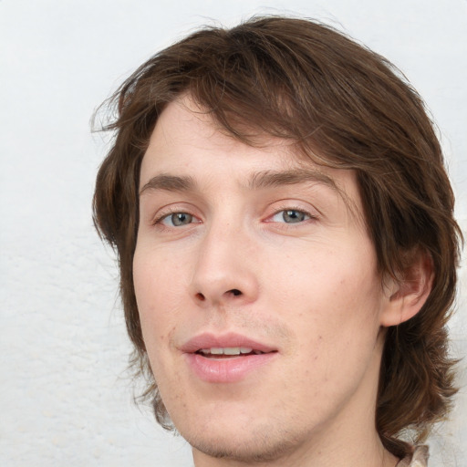 Joyful white young-adult male with medium  brown hair and blue eyes