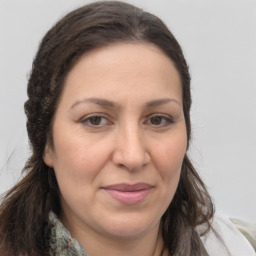 Joyful white adult female with long  brown hair and brown eyes