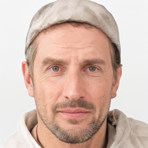 Joyful white adult male with short  brown hair and grey eyes