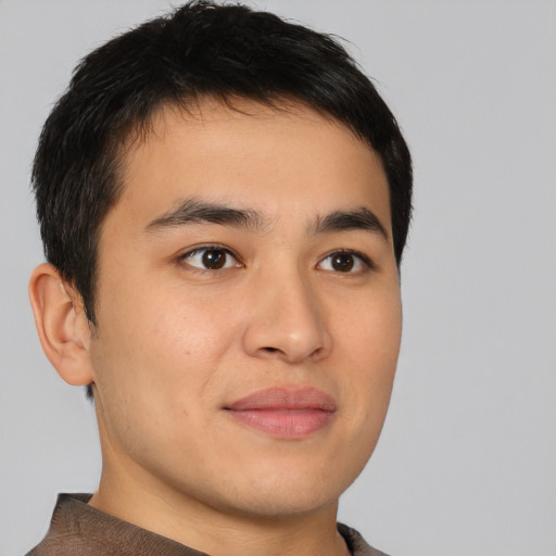 Joyful asian young-adult male with short  brown hair and brown eyes