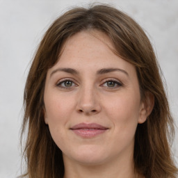 Joyful white adult female with long  brown hair and brown eyes