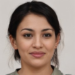 Joyful latino young-adult female with medium  brown hair and brown eyes