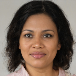 Joyful black adult female with medium  brown hair and brown eyes