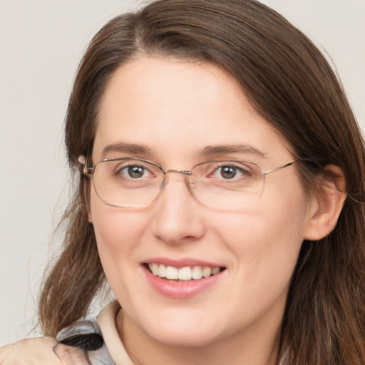 Joyful white adult female with long  brown hair and brown eyes