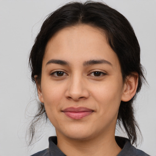 Joyful latino young-adult female with medium  brown hair and brown eyes