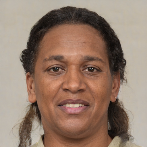 Joyful black adult female with short  brown hair and brown eyes