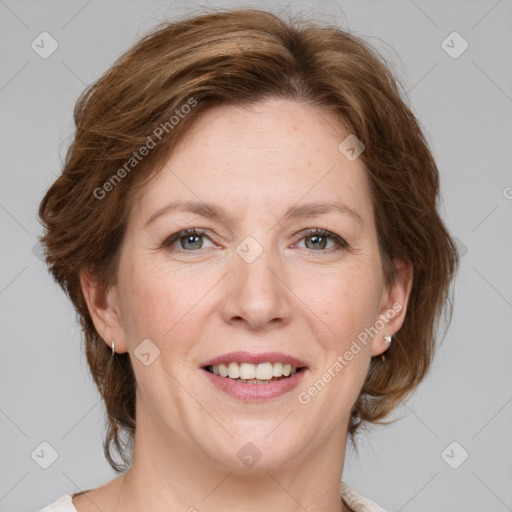 Joyful white adult female with medium  brown hair and grey eyes