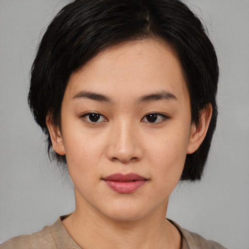 Joyful asian young-adult female with medium  black hair and brown eyes