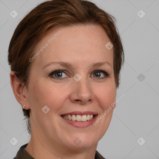 Joyful white adult female with medium  brown hair and blue eyes