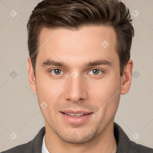 Joyful white young-adult male with short  brown hair and grey eyes