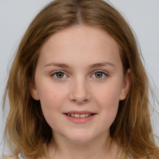 Joyful white child female with long  brown hair and blue eyes