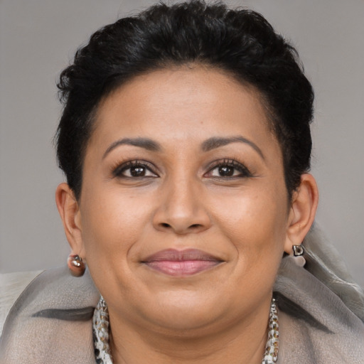 Joyful latino adult female with short  brown hair and brown eyes