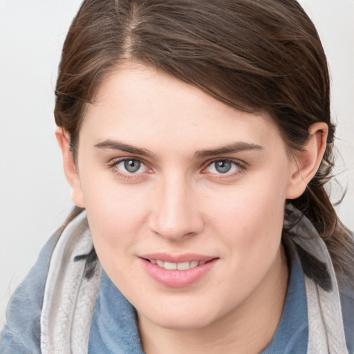 Joyful white young-adult female with medium  brown hair and blue eyes