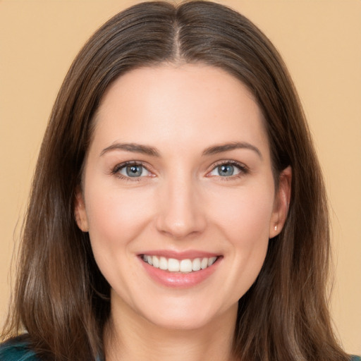 Joyful white young-adult female with long  brown hair and brown eyes