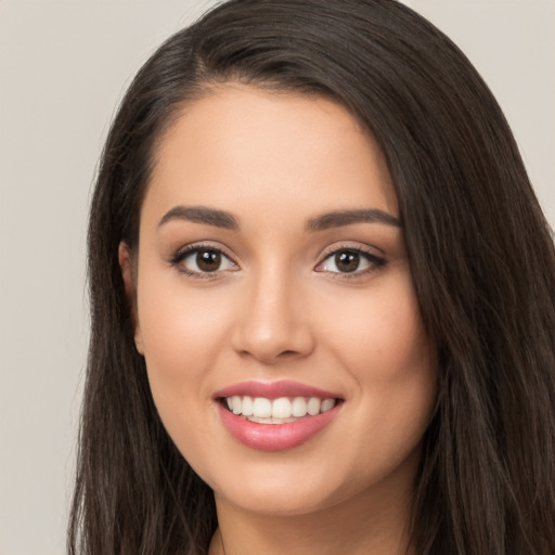 Joyful white young-adult female with long  black hair and brown eyes