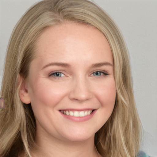 Joyful white young-adult female with long  brown hair and blue eyes