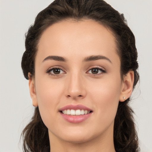 Joyful white young-adult female with long  brown hair and brown eyes