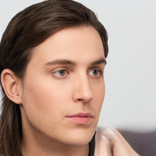 Neutral white young-adult male with long  brown hair and grey eyes