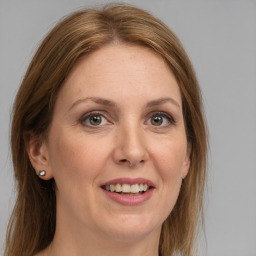 Joyful white adult female with medium  brown hair and grey eyes