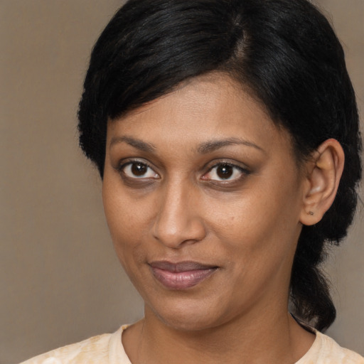 Joyful black young-adult female with medium  brown hair and brown eyes