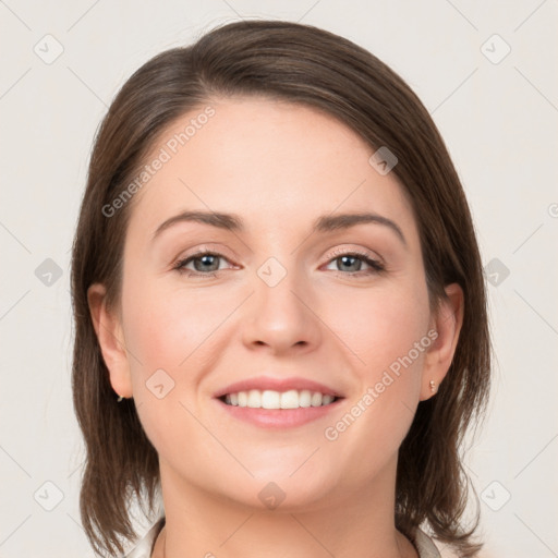 Joyful white young-adult female with medium  brown hair and grey eyes