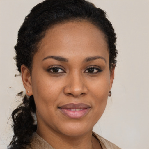 Joyful black young-adult female with long  brown hair and brown eyes