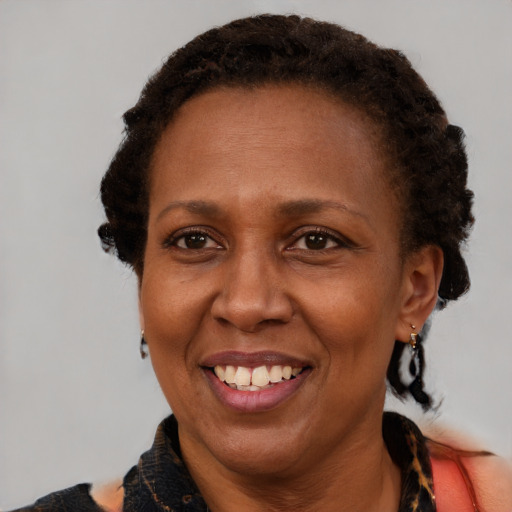 Joyful black adult female with short  brown hair and brown eyes