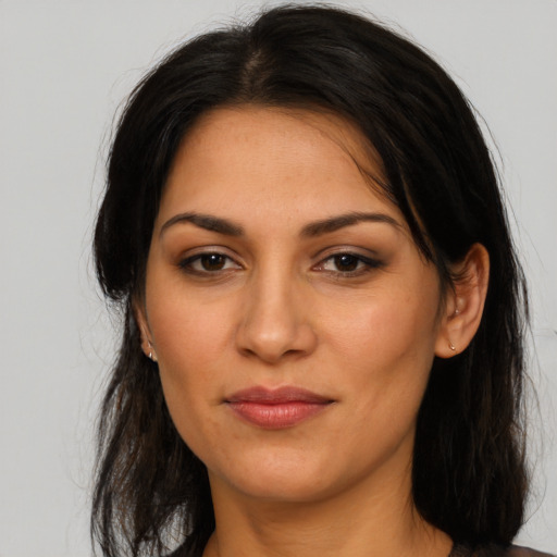 Joyful latino young-adult female with medium  brown hair and brown eyes