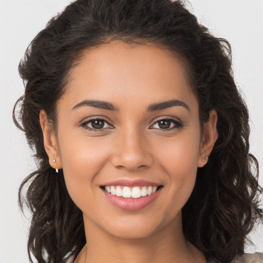 Joyful white young-adult female with long  brown hair and brown eyes