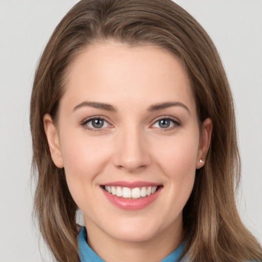 Joyful white young-adult female with long  brown hair and grey eyes