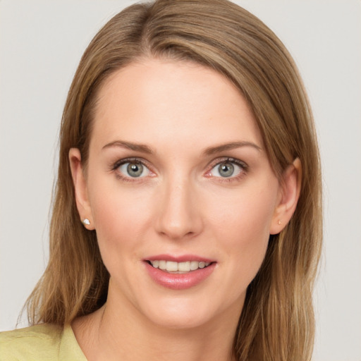 Joyful white young-adult female with long  brown hair and green eyes