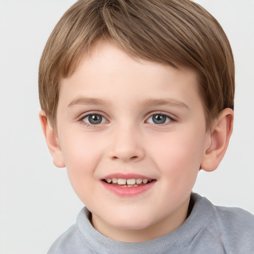 Joyful white child male with short  brown hair and grey eyes