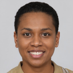 Joyful black young-adult female with short  brown hair and brown eyes