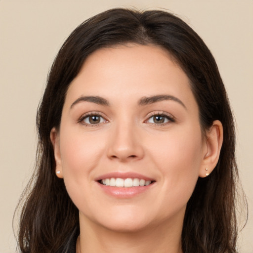 Joyful white young-adult female with long  brown hair and brown eyes