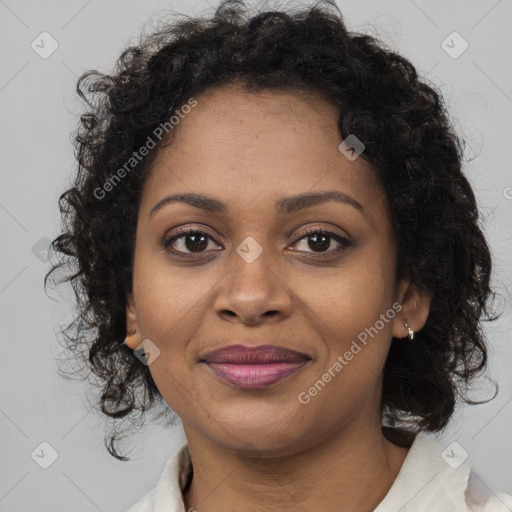 Joyful black young-adult female with long  brown hair and brown eyes