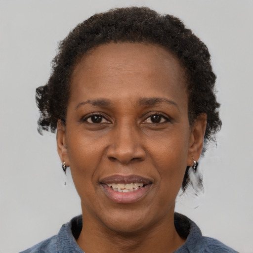 Joyful black adult female with short  brown hair and brown eyes