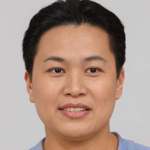 Joyful asian young-adult female with short  brown hair and brown eyes
