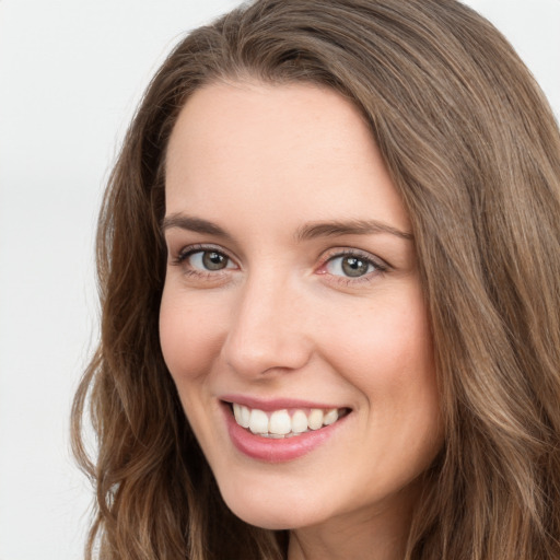 Joyful white young-adult female with long  brown hair and green eyes