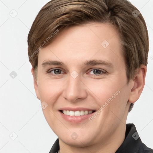 Joyful white young-adult female with short  brown hair and grey eyes