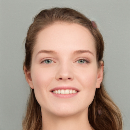 Joyful white young-adult female with long  brown hair and grey eyes