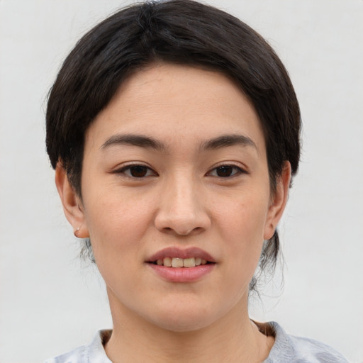 Joyful asian young-adult female with short  brown hair and brown eyes