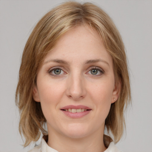 Joyful white young-adult female with medium  brown hair and blue eyes